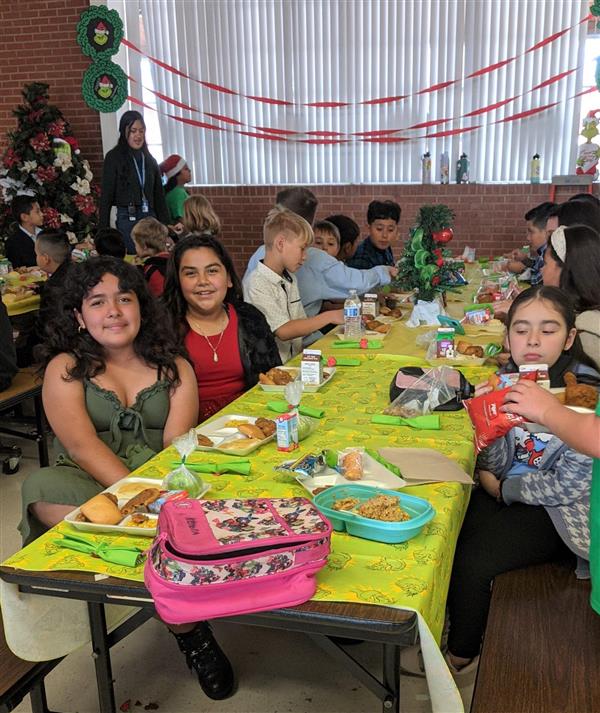 Students dress up and get served a fine meal. 